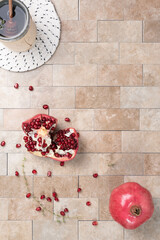 Fresh, ripe pomegranate on a tile background.