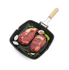 Grill pan with pieces of fresh beef meat, thyme and spices isolated on white
