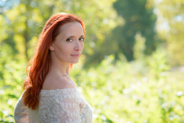 Modern image of a girl with red hair and brown eyes, in a casual style, feeling free