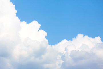 White cumulus clouds on a blue sky. Ready background with sky