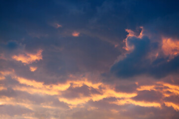 Sky with clouds at sunset. Yellow-blue clouds in the evening