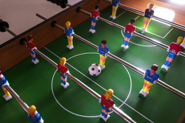 Table football game in progress creates a sense of excitement and competition
