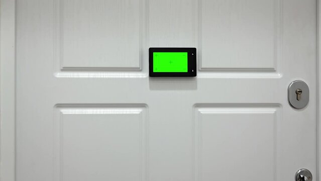 green video screen of a peephole or intercom on the front door. video surveillance system for home.