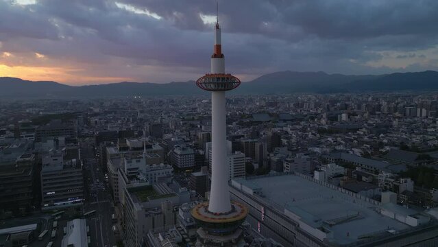 alt flying counter clockwise around Kyoto Tower at sunset