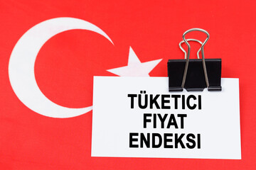 Fototapeta premium On the flag of Turkey lies a business card with the inscription - consumer price index
