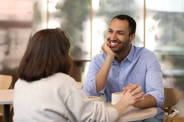 Romantic date. Happy couple spending time together in cafe