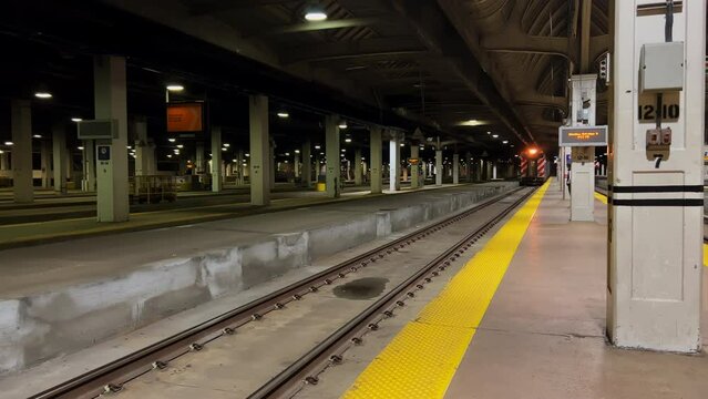 A train arrives at a train station. 