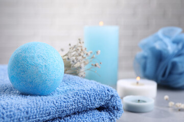 Beautiful aromatic bath bomb on towel, closeup. Space for text
