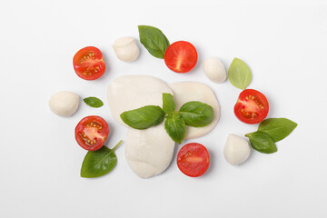 Fototapeta na wymiar Mozzarella, tomatoes and basil on white background, flat lay. Caprese salad ingredients