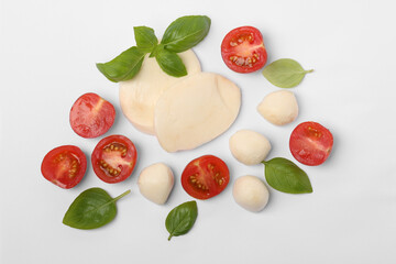 Mozzarella, tomatoes and basil on white background, flat lay. Caprese salad ingredients