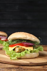 Delicious burger with tofu and fresh vegetables on wooden table