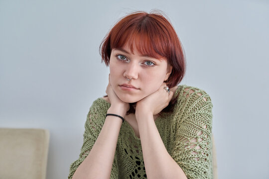 Sad upset teenage female, red-haired girl 19, 20 years old face close-up
