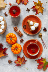 Pumpkin cheesecake with meringue on the cozy autumn background wiph pumpkins and autumn leaves