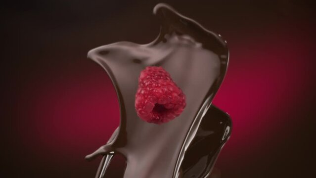 Dark chocolate and fresh raspberry falling in slow motion