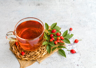 Rosehip tea on a wooden background 