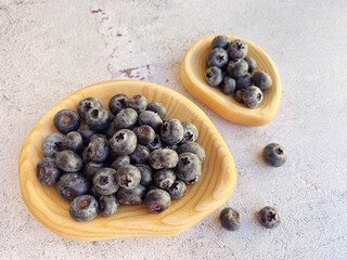Fresh blueberries in a wooden  bow