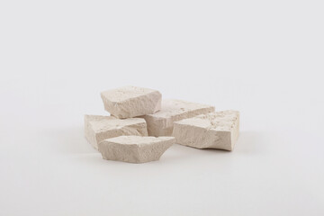 Empty stack of stones platform podium on light beige background. Minimal empty display product presentation scene.