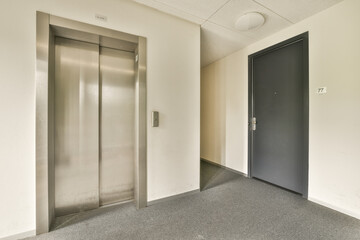 an empty office with two elevators in the middle and one on the other side, taken from above to the floor