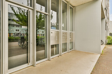 a bike parked in front of a building with glass doors on both sides and an open door to the other side