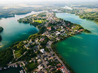 Aerial view of the picturesque Trakai, Lithuania, surrounded by a tranquil lake and lush greenery