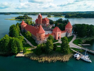 Aerial view of the historic Trakai Castle surrounded by water in Lithuania