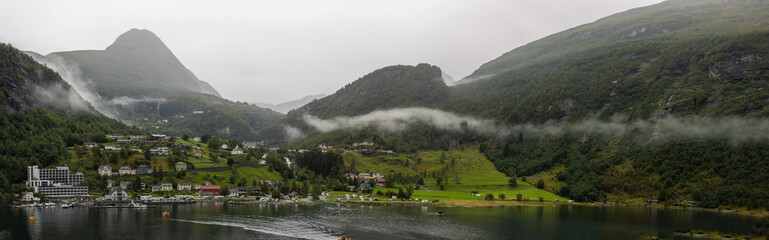 Panoramic of the town of Geiranger arriving by cruise ship, one of the busiest places in the country. Geiranger is a nice little place surrounded by spectacular surroundings, Norway