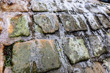 The surface of the cobblestones is covered with ice