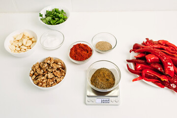 Weighing portions of ingredients to prepare a dish.