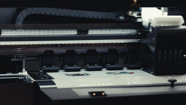 Printing Logos. Sewing Factory Logo. Printer Prints on the Clothes.