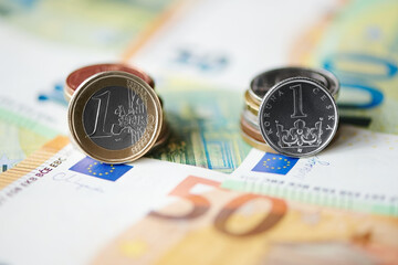 One czech crown and euro coin on euro bills background. Czech crown exchange rate to euro