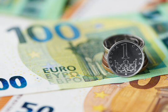 One czech crown coin on euro bills background. Czech crown exchange rate to euro