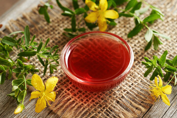 A bowl of homemade red oil made from fresh St. John's wort flowers in summer