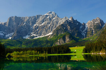 Fototapeta na wymiar Incredible view of Fusine lake in summer. Popular travel destination of Julian Alps. Location: Tarvisio comune , Province of Udine, Italy, Europe