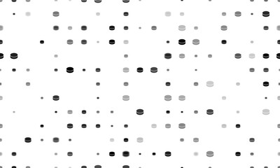 Seamless background pattern of evenly spaced black hockey pucks of different sizes and opacity. Illustration on transparent background