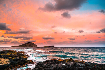 Tranquil sunset on rocky Makapu'u beach of the Island of Oʻahu in the Hawaiian Islands, United...