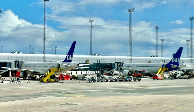 copenhagen, denmark - July 26 2023: SAS planes have been parked at the gate of the modern airport terminal of the city