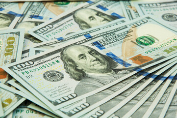 many hundred dollar bills on the table. the concept of successful enrichment