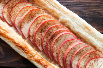 cake with apples sprinkled with cinnamon. homemade crispy pastry with chopped fruit