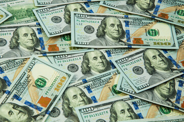 many hundred dollar bills on the table. the concept of successful enrichment