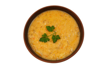 pea soup with a sprig of parsley in a clay plate