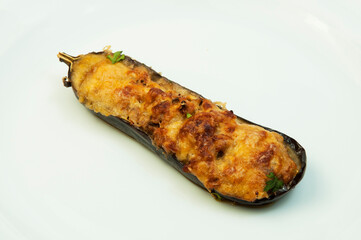 baked eggplant with vegetables and cheese on a white plate