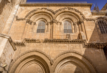 The fascade windows and so called "immovable ladder" over the entrance of the Church of the Holy Sepulchre, the most sacred Christian temple, in Old City of Jerusalem, Israel.