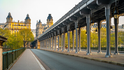 Promenade Jean-Paul Belmondo. Long row of metal columns of elevated subway. Bir Hakeim Bridge in...