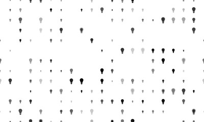 Seamless background pattern of evenly spaced black lamp symbols of different sizes and opacity. Vector illustration on white background