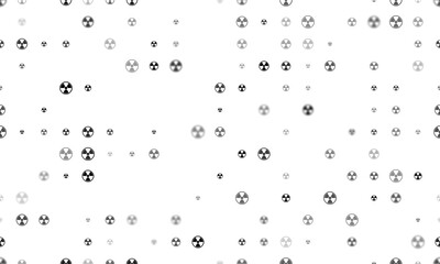 Seamless background pattern of evenly spaced black radiation symbols of different sizes and opacity. Illustration on transparent background