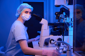 Lab scientist posing for camera in her workplace