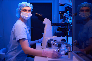Serious female embryologist posing for camera in lab