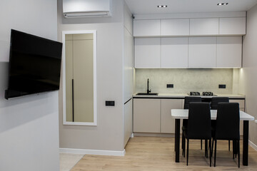 Interior of light kitchen with dining table.