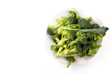 Healthy Green Organic Raw Broccoli Florets Ready for Cooking on white background. top view 