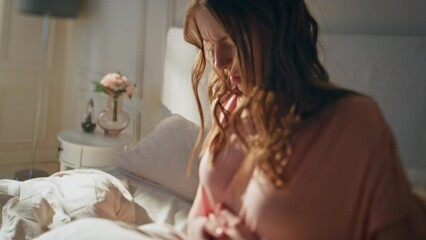 Closeup frustrated girl waking up with pain. Unhappy woman feeling stomach ache